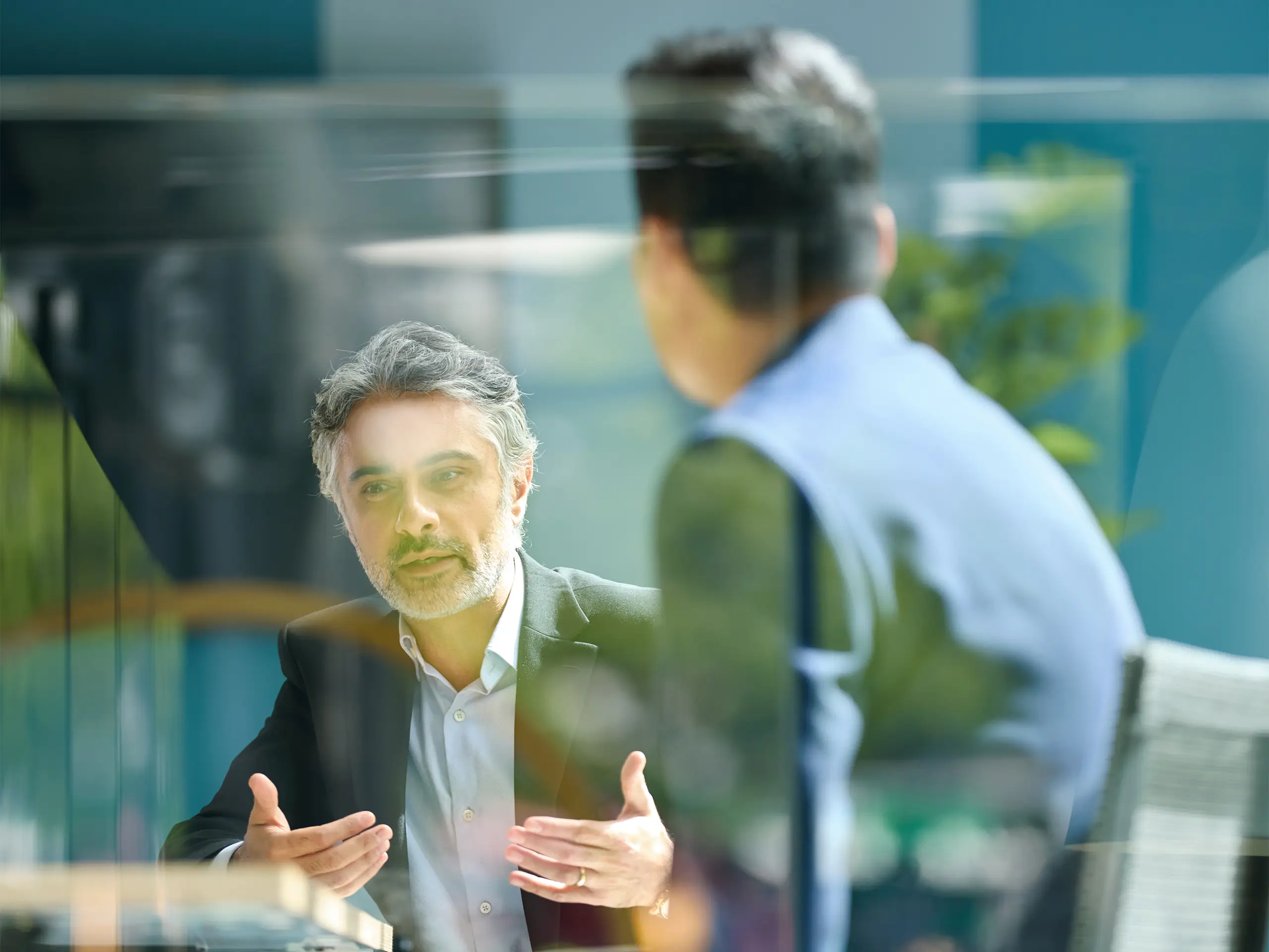 Medium shot of businessman discussing project with colleague